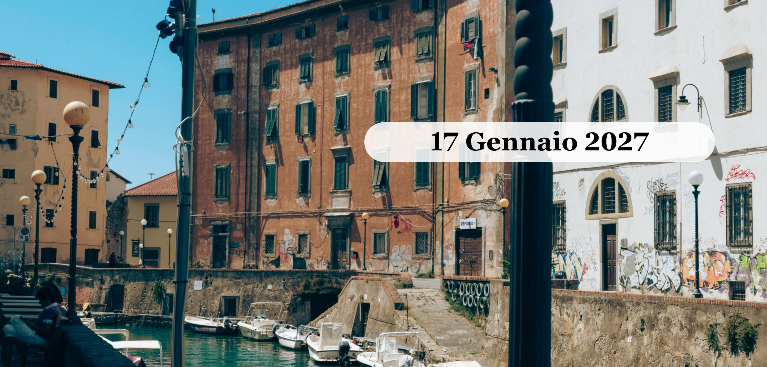 Livorno: City Tour e Cacciuccata Gennaio 2027 Un canale della Venezia Nuova a Livorno con le barche ormeggiate e i palazzi storici